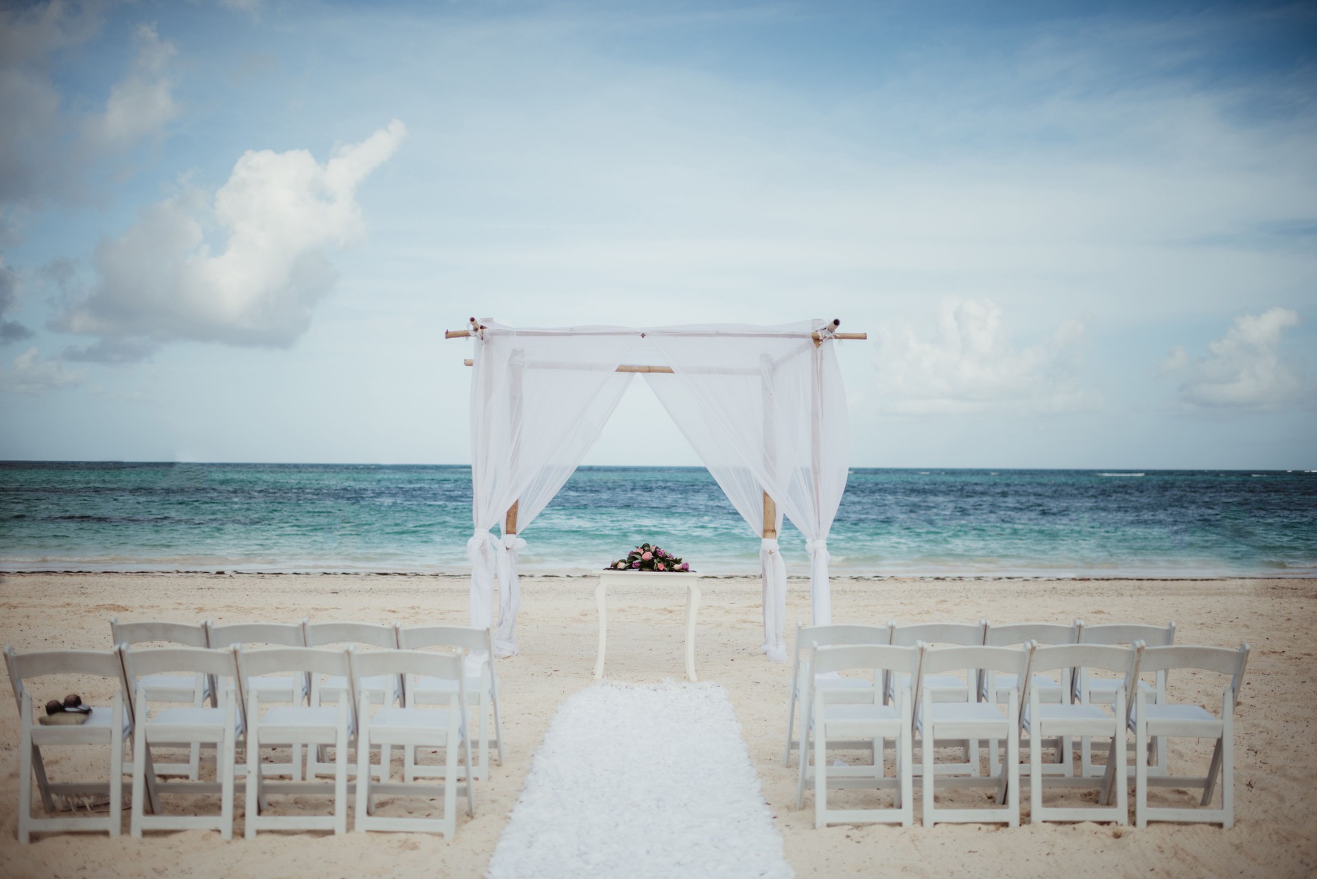 Destination wedding ceremony site on the beach next to the ocean