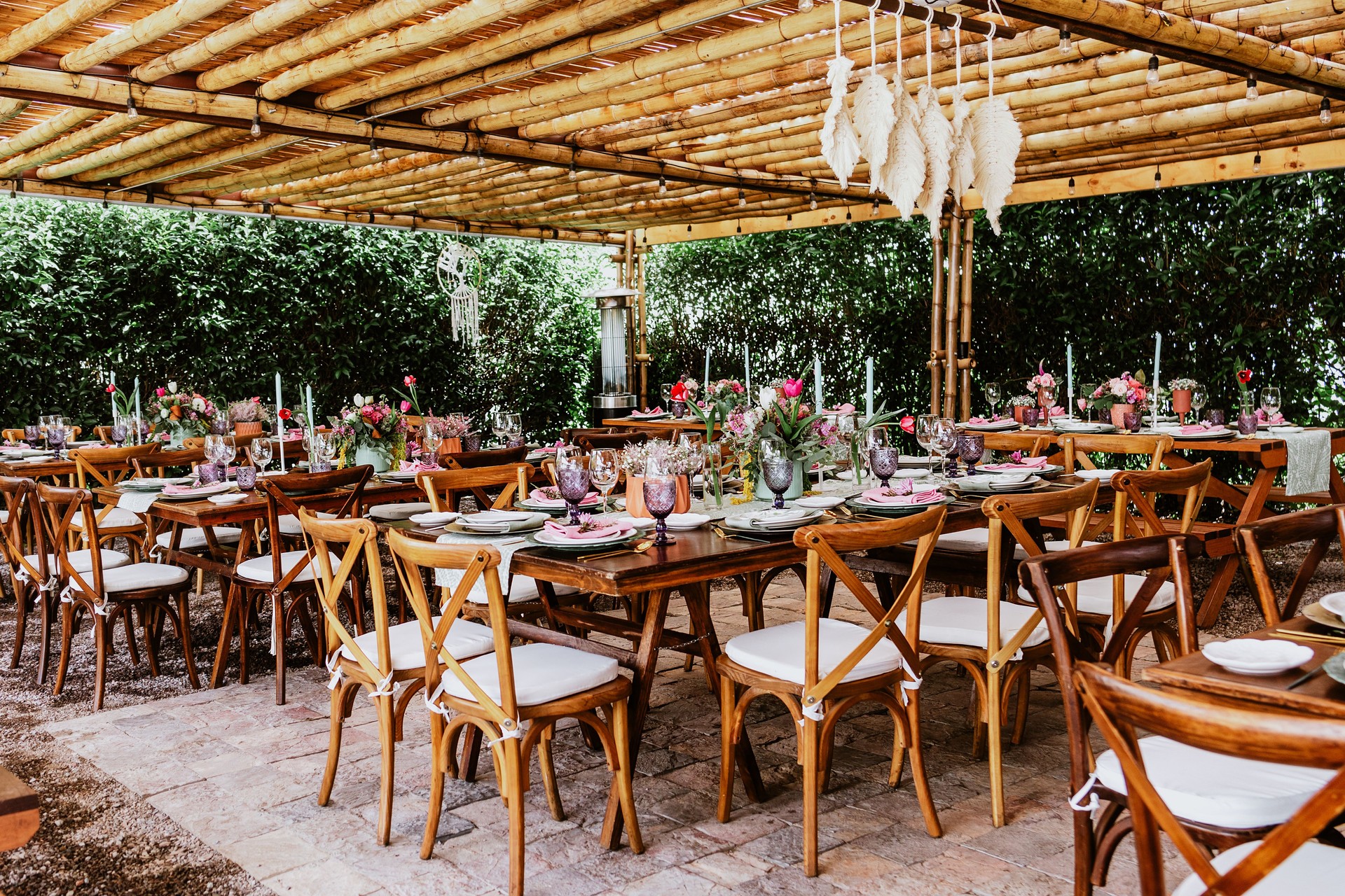 terrace with tables setup with flowers and plates on table decorated for Wedding Reception in Latin America